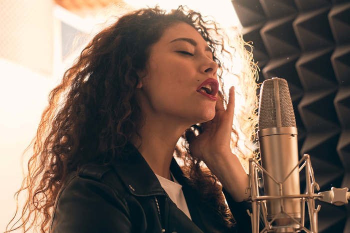 Female singing in studio